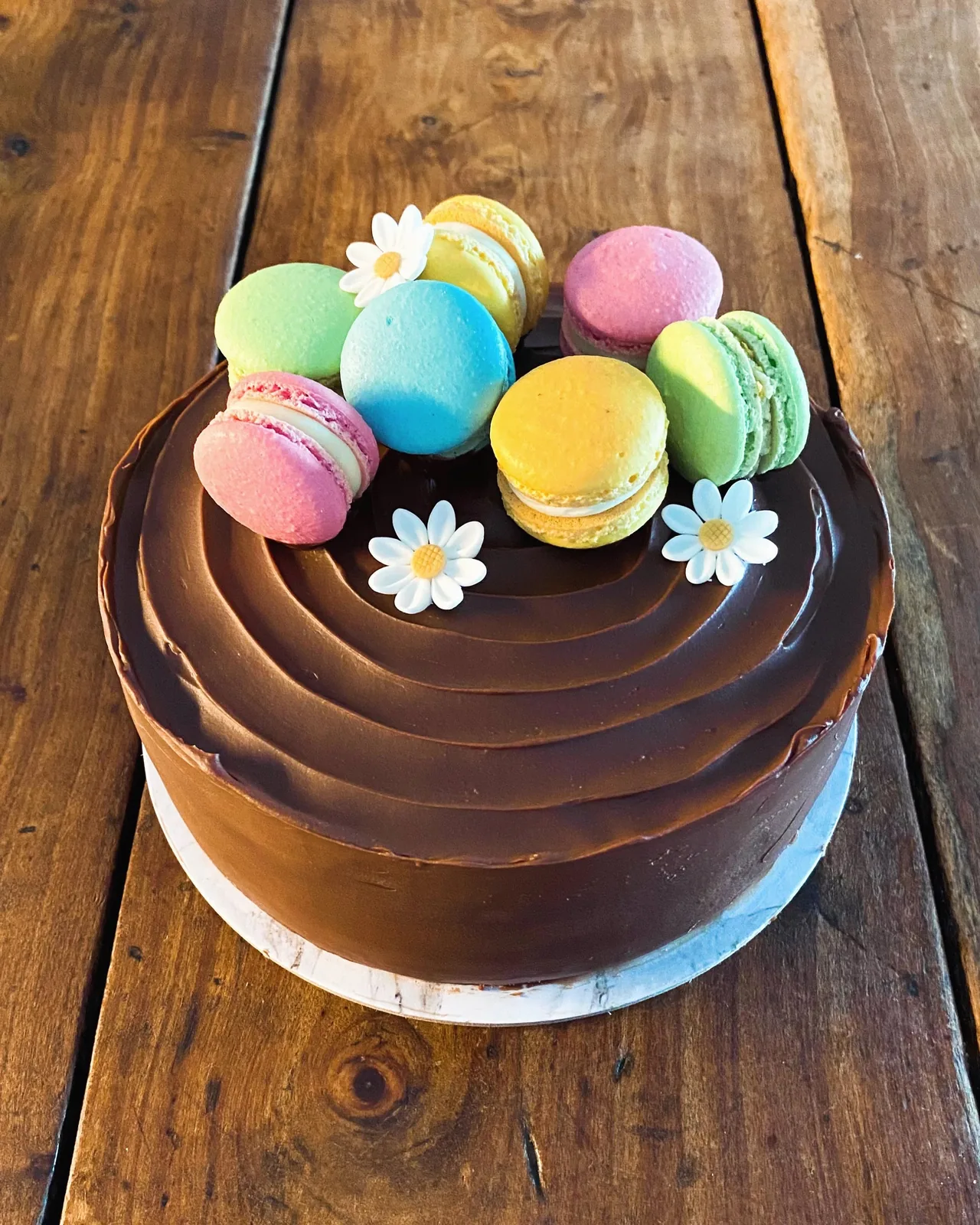 Torta decorata con glassa al cioccolato e decorazioni pastello